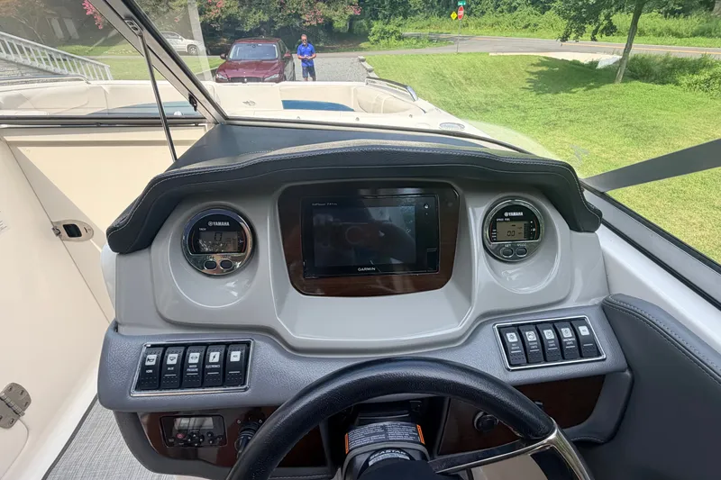 Slide: The Image of Dashboard of a 2016 Chaparral 250 Suncoast boat with Yamaha controls and Garmin display. - 16