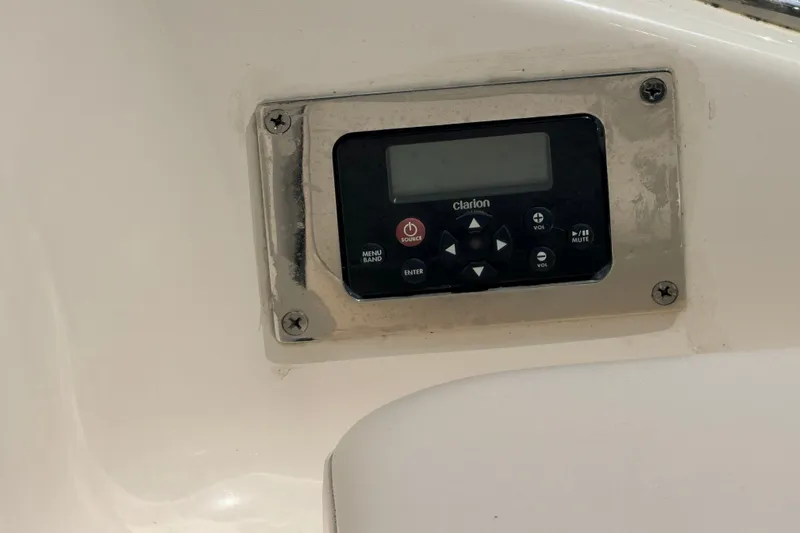 Slide: The Image of Clarion audio control panel on 2016 Chaparral 250 Suncoast boat dashboard. - 30