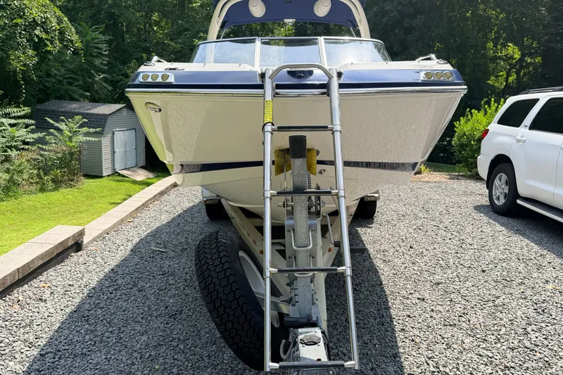 Slide: The Image of 2016 Chaparral 250 Suncoast boat on trailer, parked on gravel driveway. - 10