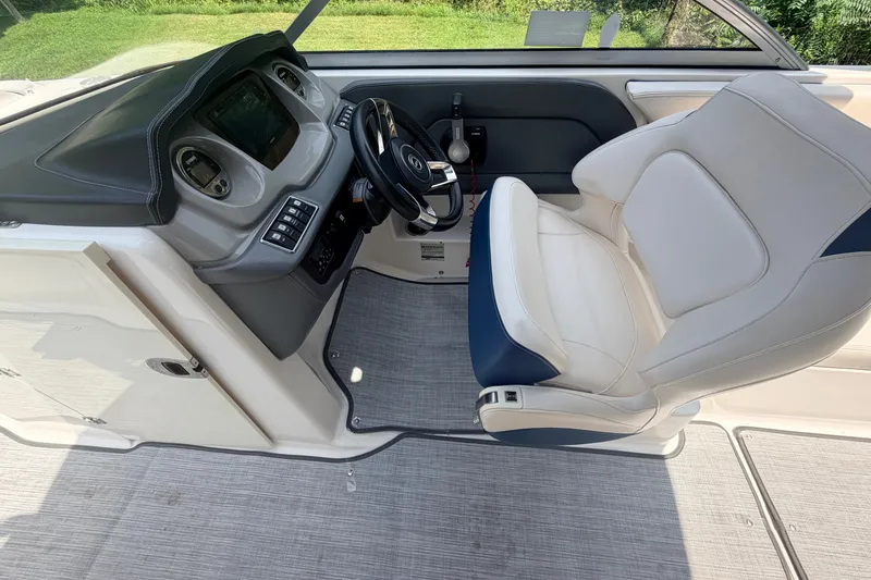 Slide: The Image of Interior of 2016 Chaparral 250 Suncoast boat, featuring helm and captain's chair. - 24