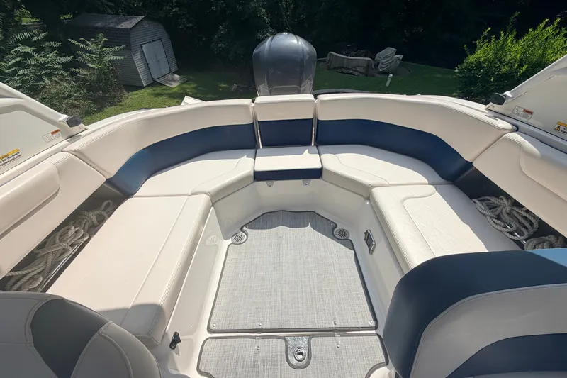 Slide: The Image of 2016 Chaparral 250 Suncoast boat interior with spacious seating and storage compartments. - 19