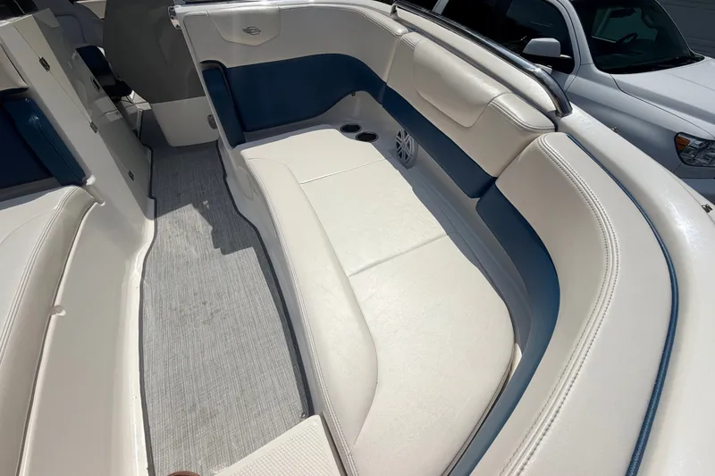 Slide: The Image of Interior view of a 2016 Chaparral 250 Suncoast boat with white and blue seating. - 22