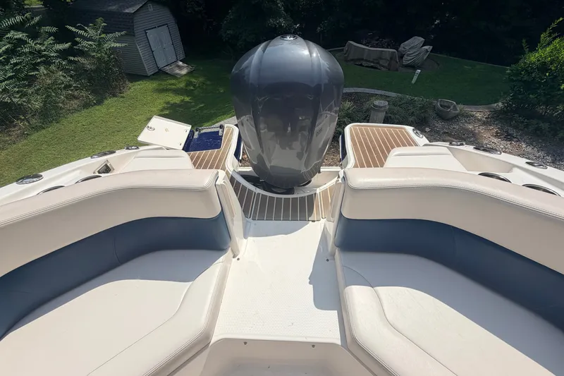 Slide: The Image of 2016 Chaparral 250 Suncoast boat interior with seating and outboard motor. - 26