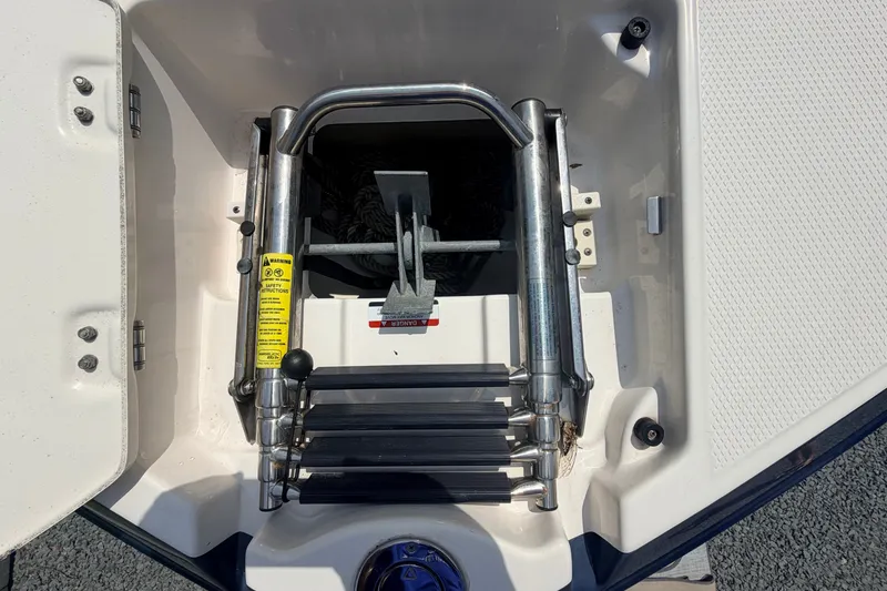 Slide: The Image of 2016 Chaparral 250 Suncoast boat anchor storage compartment with ladder. - 44