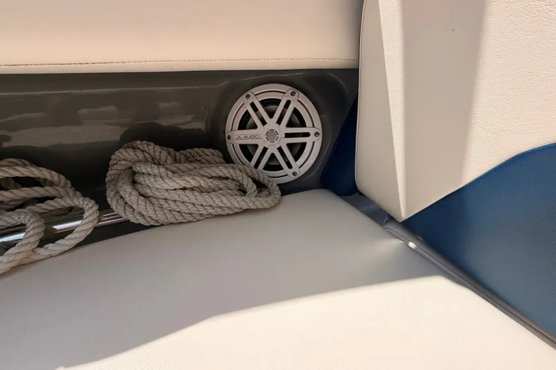 Slide: The Image of 2016 Chaparral 250 Suncoast boat interior with JL Audio speaker and coiled rope. - 35