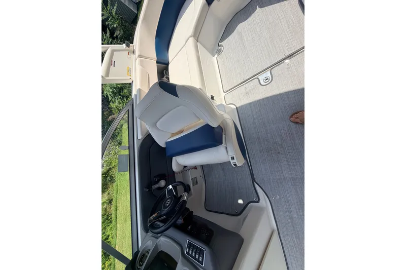 Slide: The Image of 2016 Chaparral 250 Suncoast boat interior with steering wheel and seating. - 21