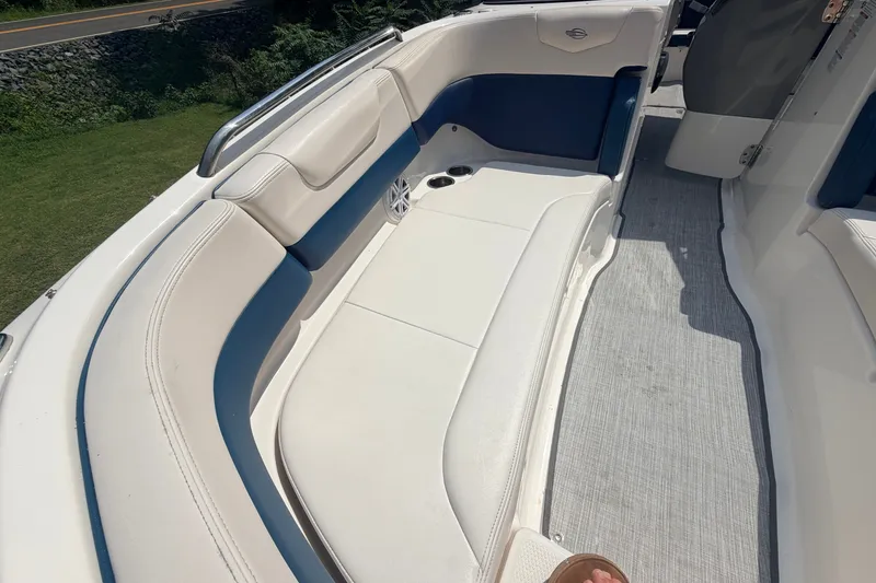 Slide: The Image of 2016 Chaparral 250 Suncoast boat interior with white and blue seating. - 23