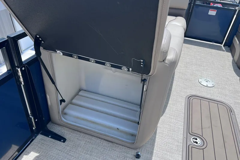Slide: The Image of Open storage compartment on a 2020 Regency 250 DL3 boat with beige interior. - 28