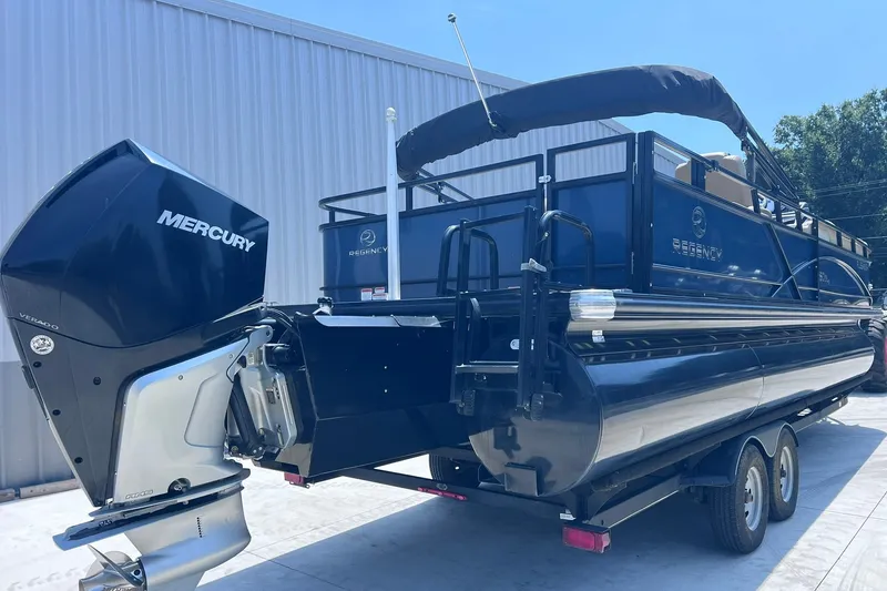 Slide: The Image of 2020 Regency 250 DL3 pontoon boat with Mercury engine, parked on a trailer. - 8