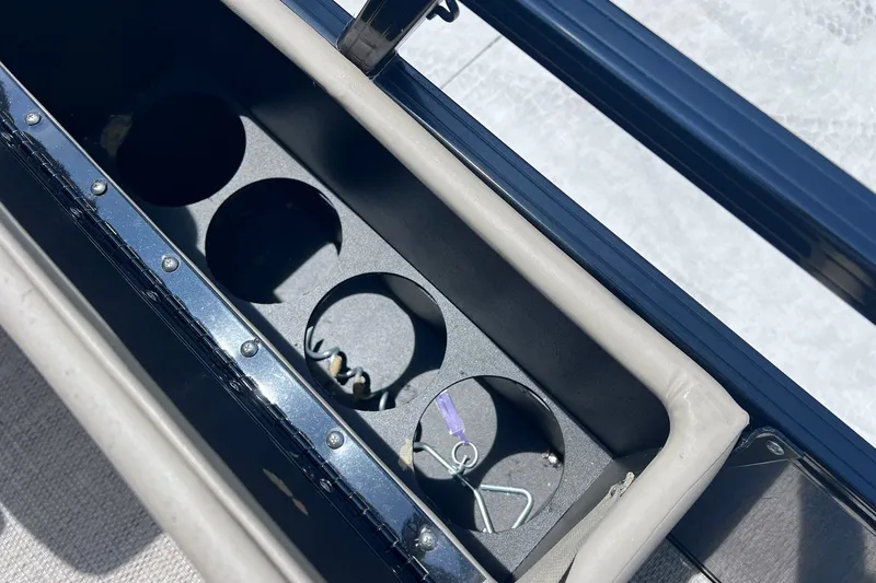 Slide: The Image of Cup holder compartment on a 2020 Regency 250 DL3 boat, featuring multiple slots. - 30