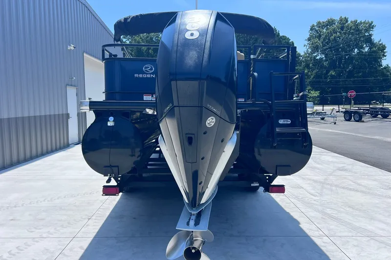 Slide: The Image of 2020 Regency 250 DL3 pontoon boat with powerful outboard motor, parked outdoors. - 7