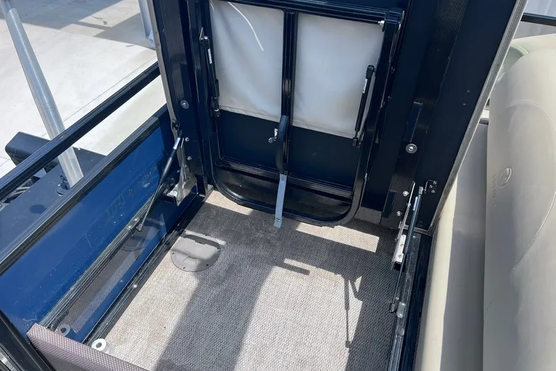 Slide: The Image of Interior view of a 2020 Regency 250 DL3 boat, featuring seating and flooring details. - 29