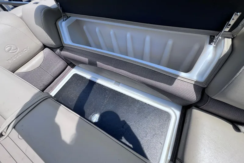 Slide: The Image of Open storage compartment in 2020 Regency 250 DL3 boat with cushioned seating. - 27