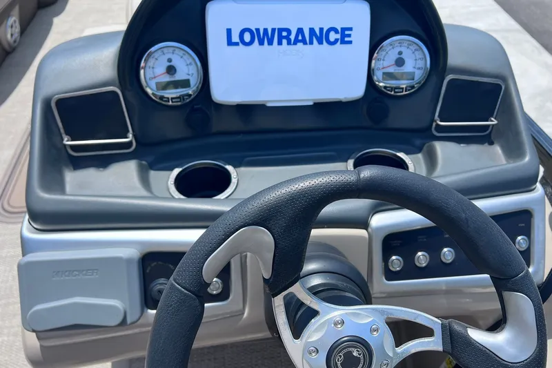 Slide: The Image of Steering console of 2020 Regency 250 DL3 boat with Lowrance display and gauges. - 16