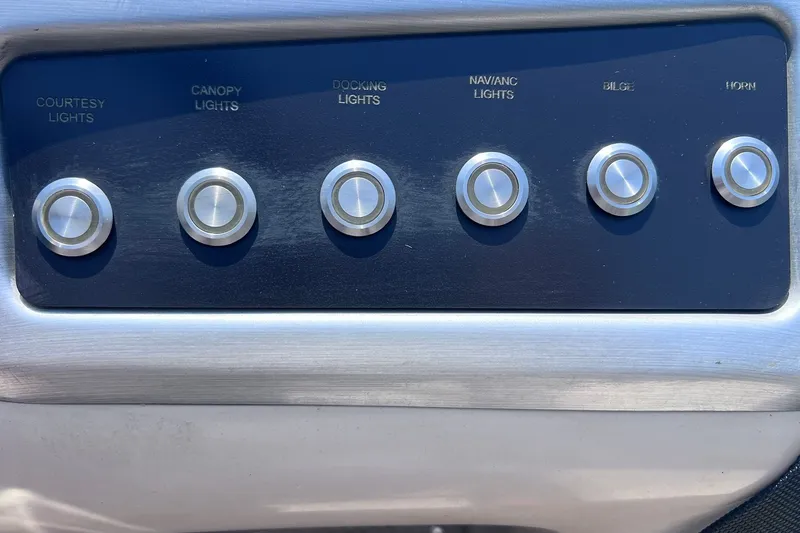 Slide: The Image of Control panel of a 2020 Regency 250 DL3 boat with labeled buttons for various functions. - 17