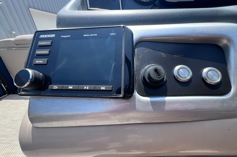 Slide: The Image of Control panel of a 2020 Regency 250 DL3 boat featuring a Kicker media center. - 20