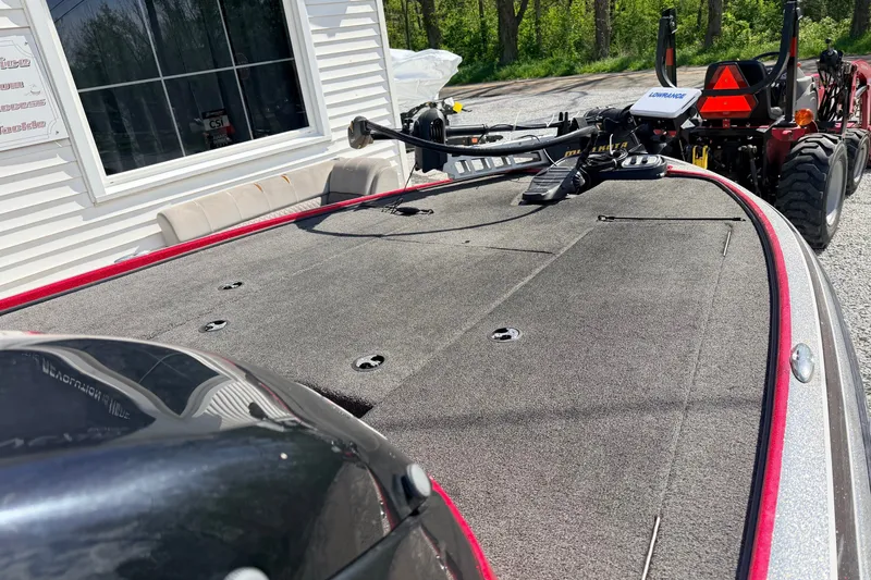 Slide: The Image of 2015 Nitro Z-7 boat deck with fishing equipment, parked near a building. - 6