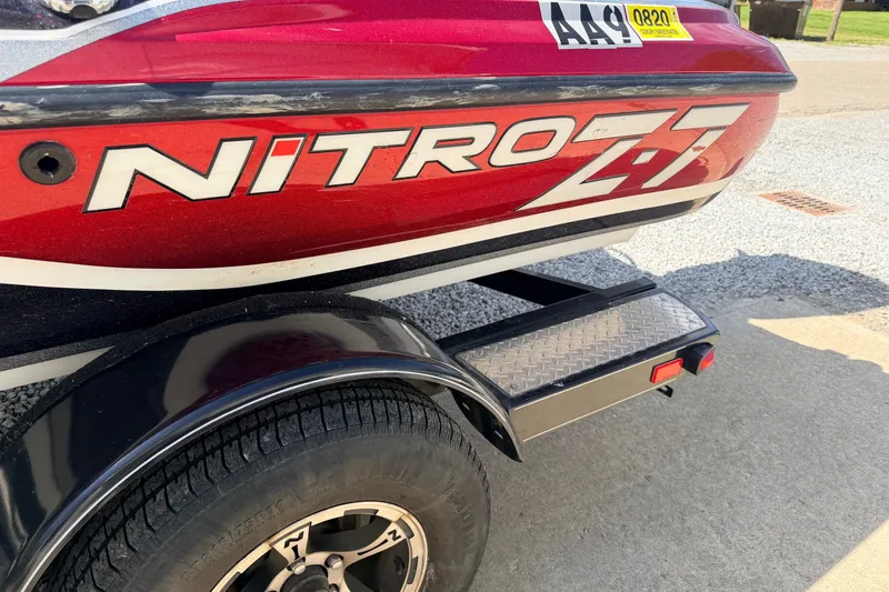 Slide: The Image of Red 2015 Nitro Z-7 boat trailer with visible tire and step detail. - 11