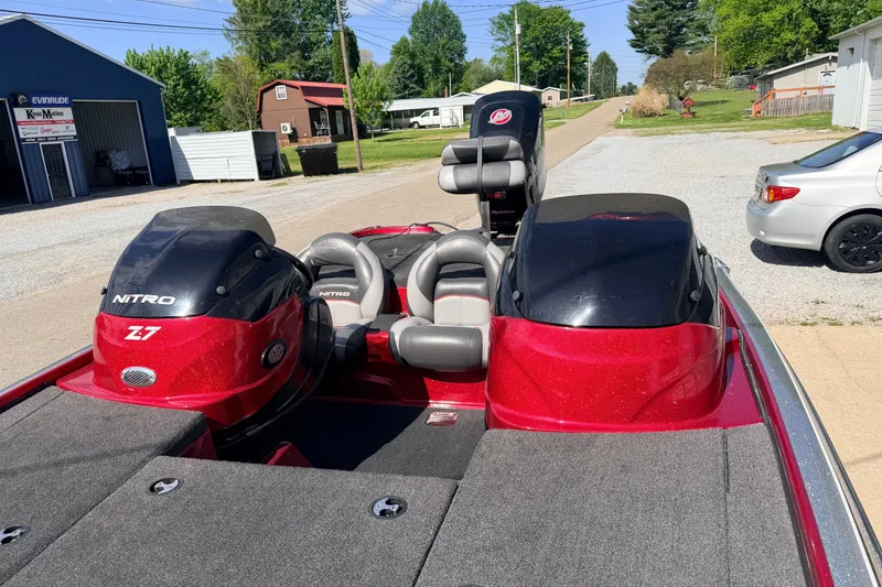 Slide: The Image of 2015 Nitro Z-7 boat with red and black design, parked outdoors on a sunny day. - 9