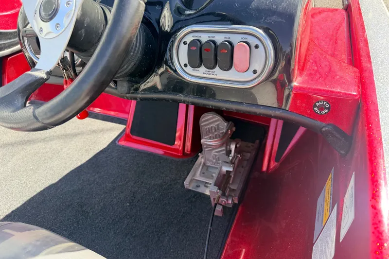 Slide: The Image of Steering wheel and controls of a 2015 Nitro Z-7 boat, featuring a red and black dashboard. - 5