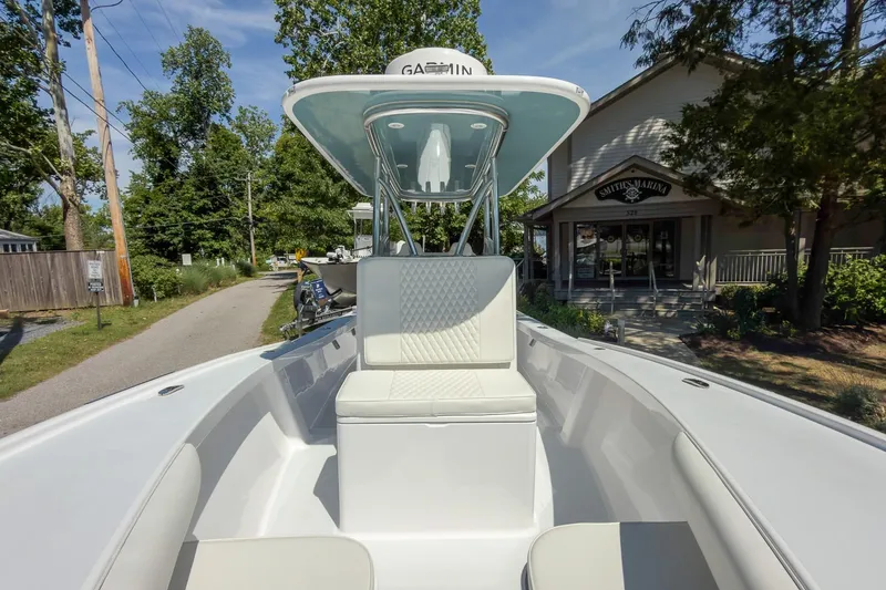 Slide: The Image of 2025 Weaver 25 boat at Smith's Marina, featuring sleek seating and Garmin equipment. - 13