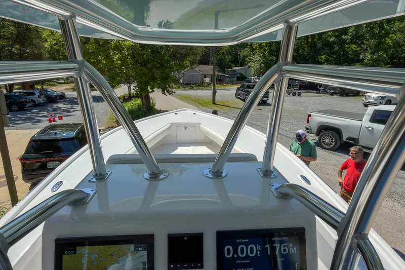 Slide: The Image of View from Weaver 25 boat cockpit, showcasing navigation screens and parked vehicles, 2025 model. - 8