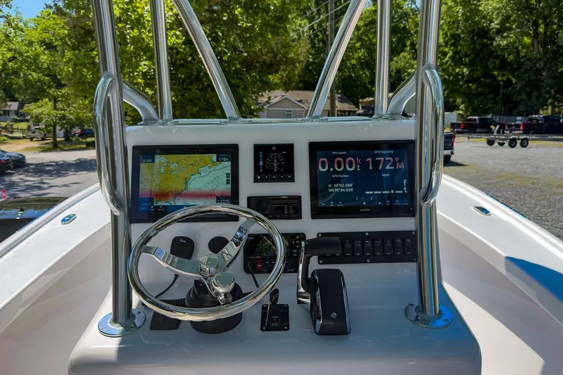 Slide: The Image of Boat dashboard with navigation screens and steering wheel, Weaver 25 model, 2025. - 7