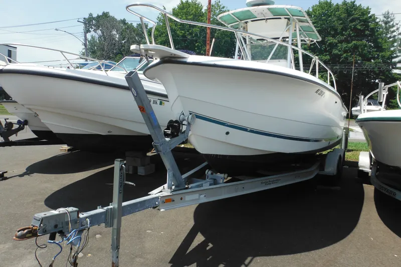 Slide: The Image of 2001 Sea Pro 235 Center Console boat on trailer, parked outdoors. - 3