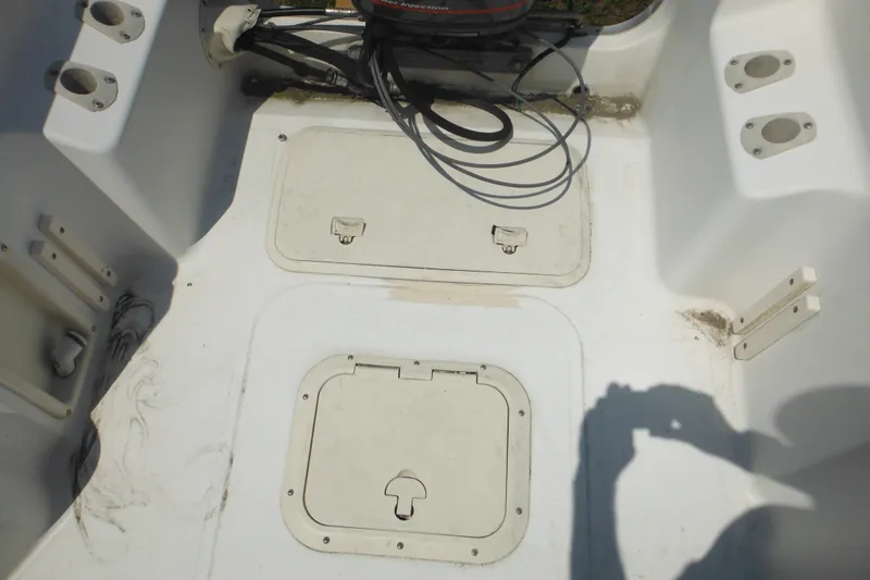 Slide: The Image of 2001 Sea Pro 235 Center Console boat deck with storage compartments and wiring. - 21
