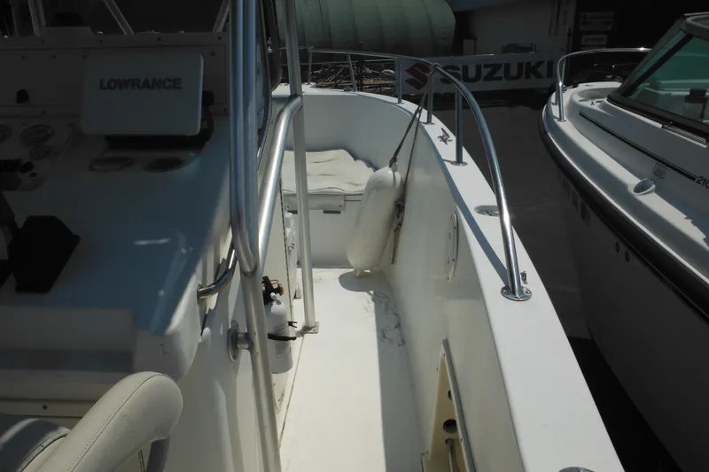 Slide: The Image of 2001 Sea Pro 235 Center Console boat interior with navigation equipment and seating. - 8