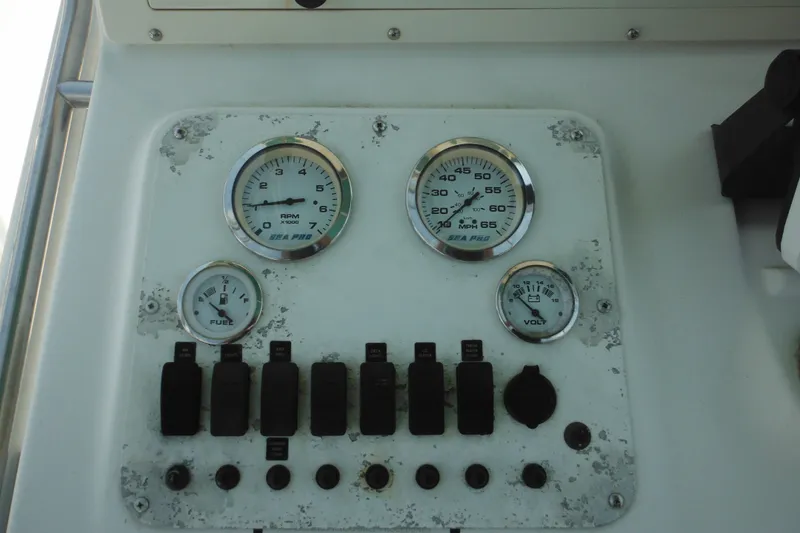 Slide: The Image of Dashboard of 2001 Sea Pro 235 Center Console with gauges and switches. - 14