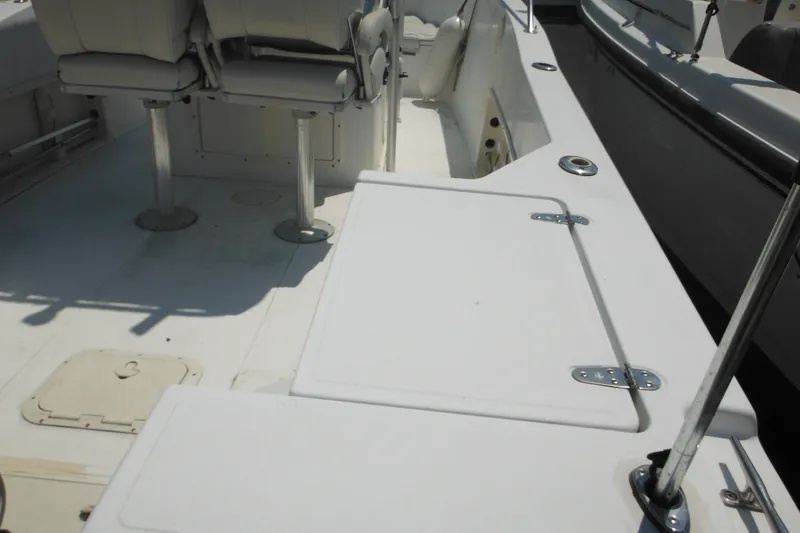 Slide: The Image of 2001 Sea Pro 235 Center Console boat interior with seating and storage compartments. - 6