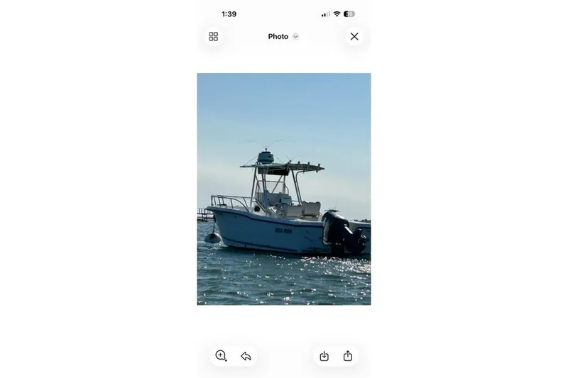 Slide: The Image of 2001 Sea Pro 235 Center Console boat on water, side view. - 33