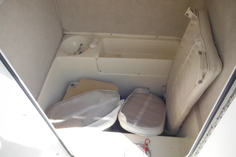 Slide: The Image of Interior of 2001 Sea Pro 235 Center Console boat with storage and cushions. - 19