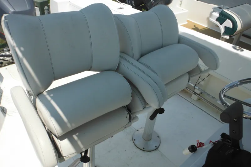 Slide: The Image of 2001 Sea Pro 235 Center Console boat with dual cushioned seats and steering wheel. - 10