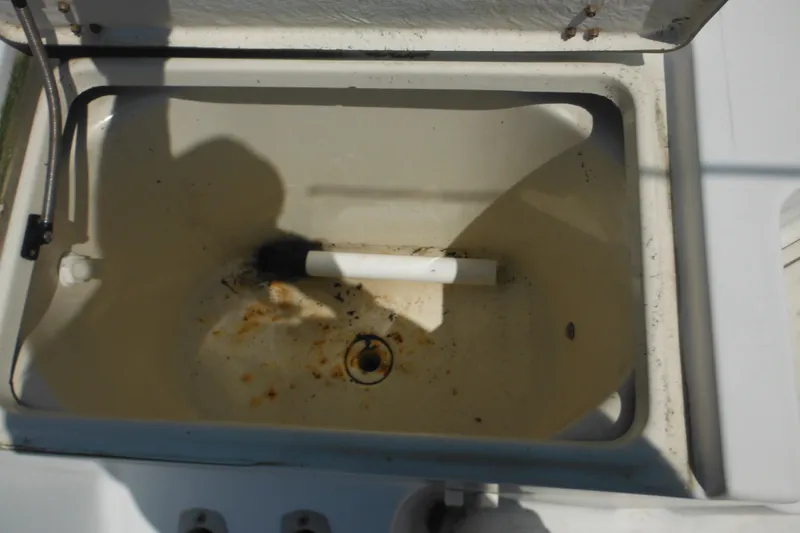 Slide: The Image of Open storage compartment on 2001 Sea Pro 235 Center Console boat, showing interior details. - 23