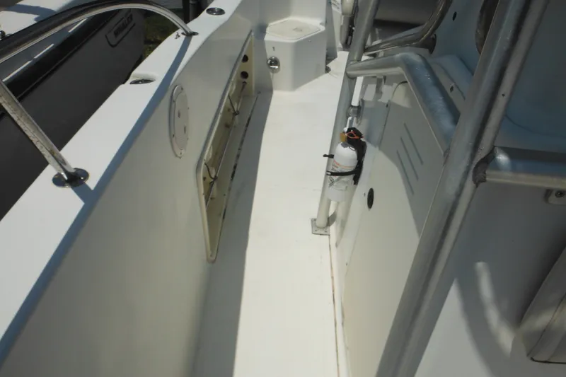 Slide: The Image of 2001 Sea Pro 235 Center Console boat interior with safety equipment and storage. - 18