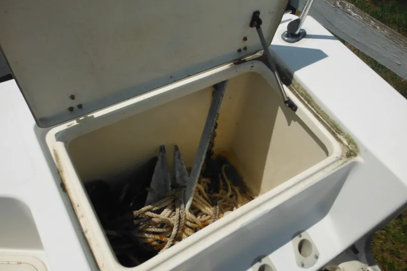 Slide: The Image of Open storage compartment on 2001 Sea Pro 235 Center Console boat with anchor and rope. - 22