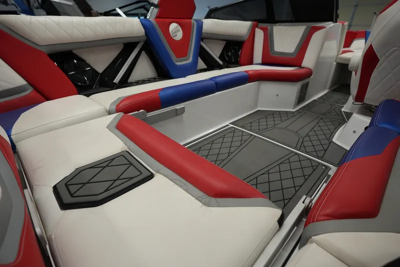 Slide: The Image of Interior of 2021 Tigé 25ZX boat with red, blue, and white seating. - 16