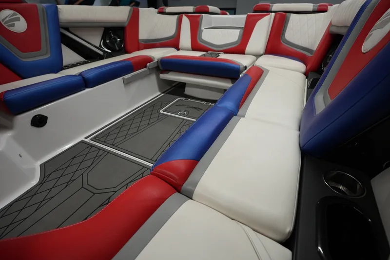 Slide: The Image of 2021 Tigé 25ZX boat interior with red, blue, and white seating, showcasing modern design. - 15