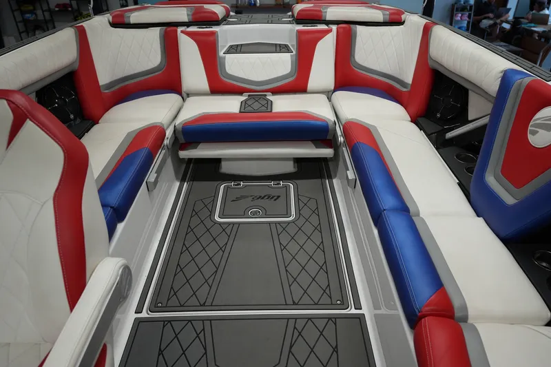 Slide: The Image of Interior of 2021 Tigé 25ZX boat with red, blue, and white seating. - 18