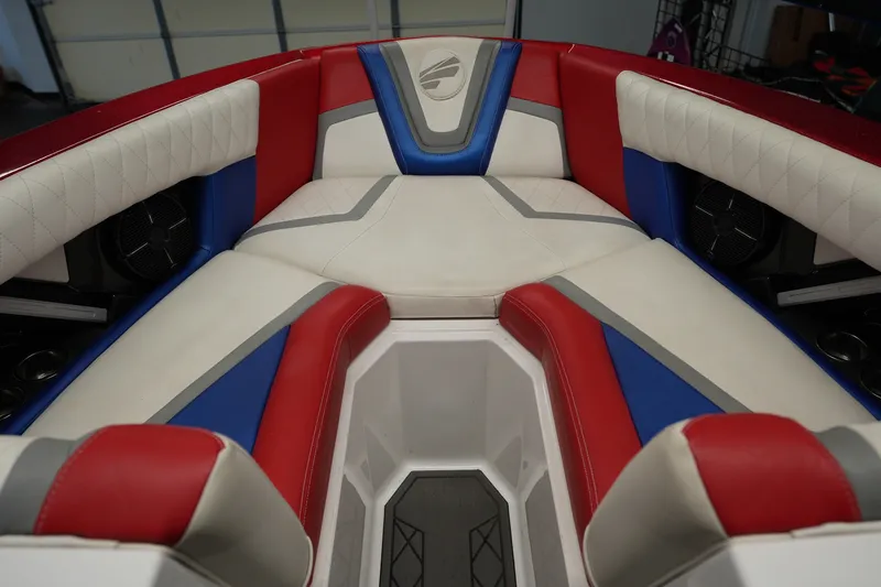 Slide: The Image of Interior of 2021 Tigé 25ZX boat with red, blue, and white seating. - 20