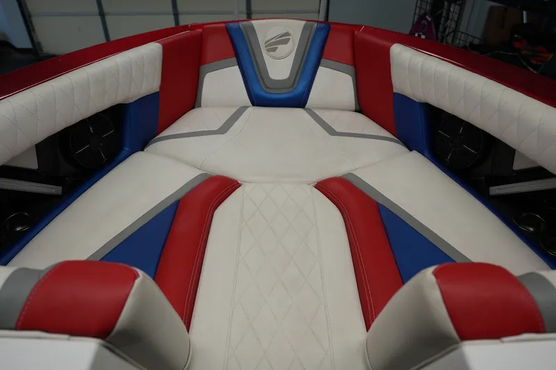 Slide: The Image of 2021 Tigé 25ZX boat interior with red, blue, and white upholstery design. - 19