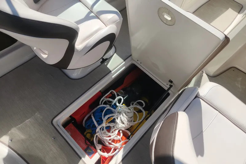 Slide: The Image of 2020 Chaparral 19 SSi boat interior storage compartment with ropes and equipment. - 20