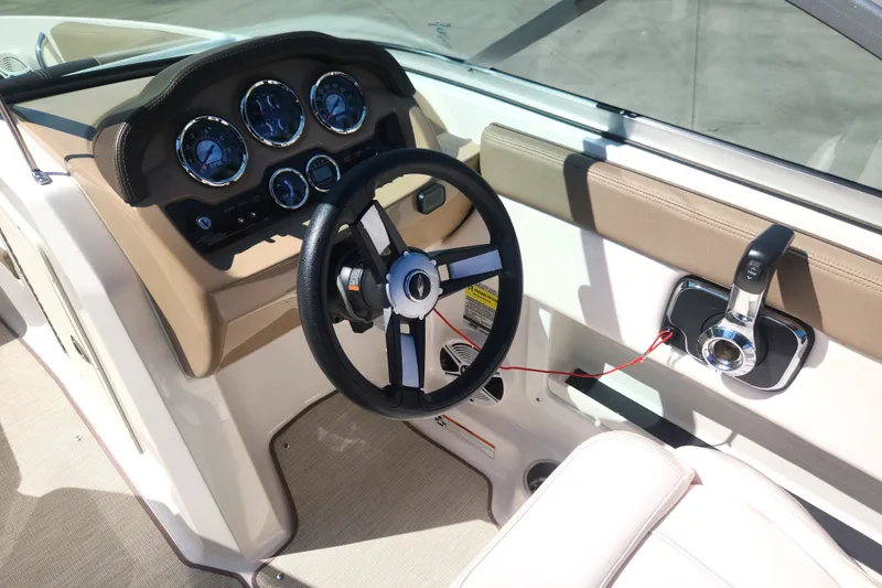 Slide: The Image of 2020 Chaparral 19 SSi boat dashboard with steering wheel and control panel. - 17