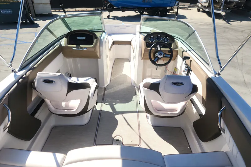 Slide: The Image of 2020 Chaparral 19 SSi boat interior with steering wheel and seating. - 15