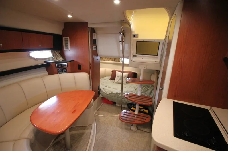 Slide: The Image of Interior of 2004 Chaparral Signature 310 yacht with cozy seating and compact kitchen area. - 22