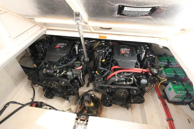 Slide: The Image of Engine compartment of a 2004 Chaparral Signature 310 boat, featuring dual engines and batteries. - 24