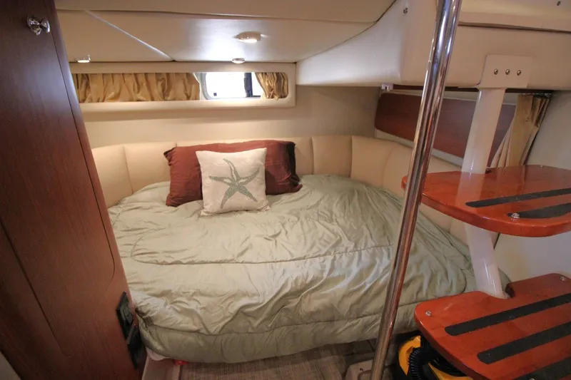 Slide: The Image of Cozy cabin interior of 2004 Chaparral Signature 310 with bed and wooden steps. - 23