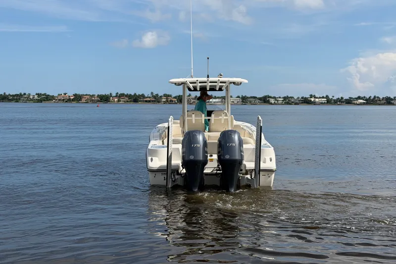 Slide: The Image of 2022 Key West 263 FS boat with dual engines on calm water. - 21